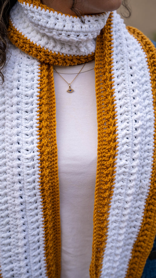 Close-up of mustard and white crochet scarf texture