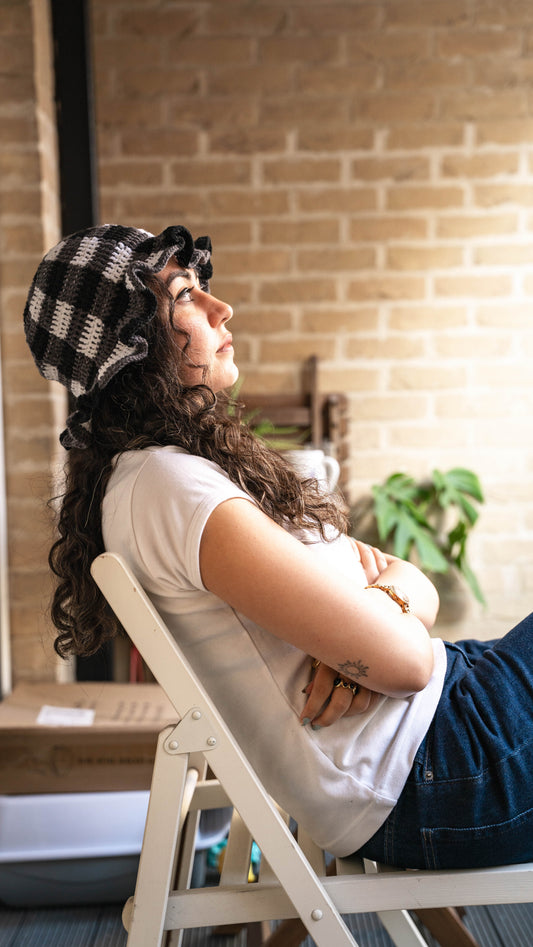 Model wearing monochrome crochet bucket hat, side view