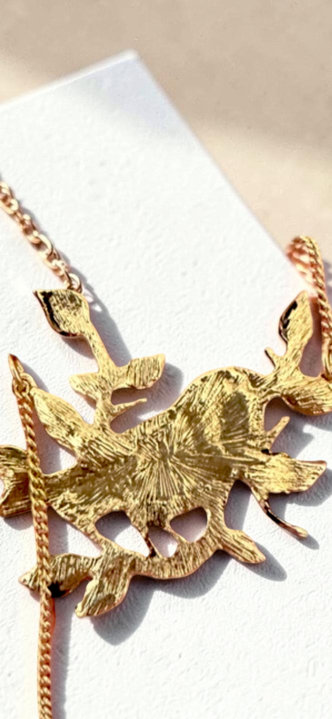 Enamel bird on branch gold tone necklace, reverse textured detail