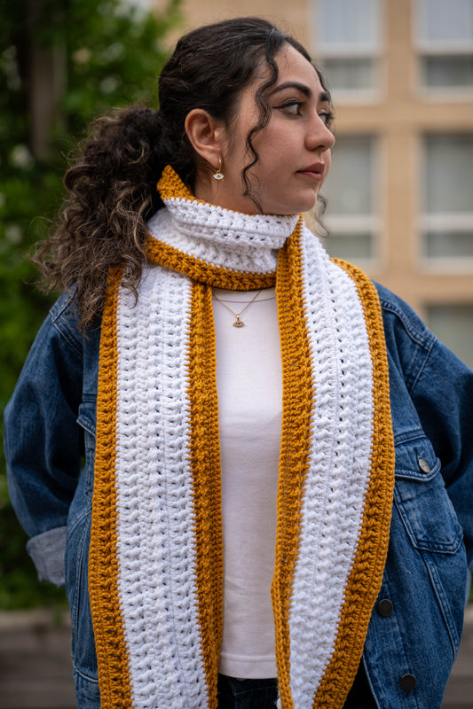 Model wearing mustard and white crochet scarf, full length view