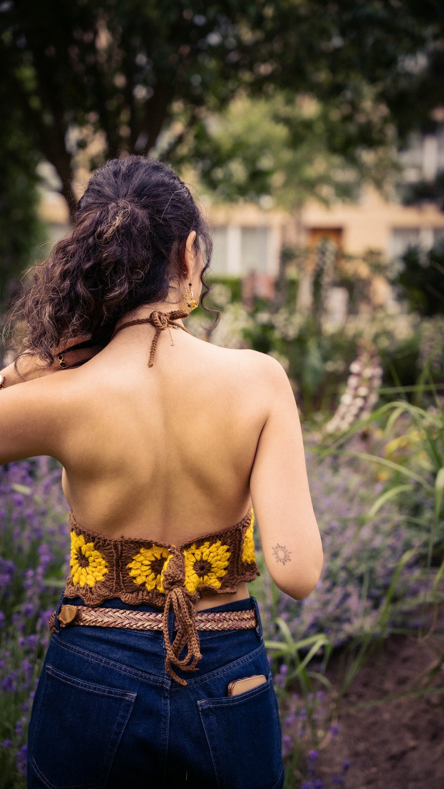 Handmade crochet sunflower halter top - back view on model