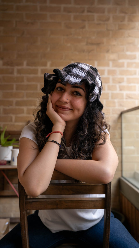 Model wearing monochrome crochet bucket hat, front view