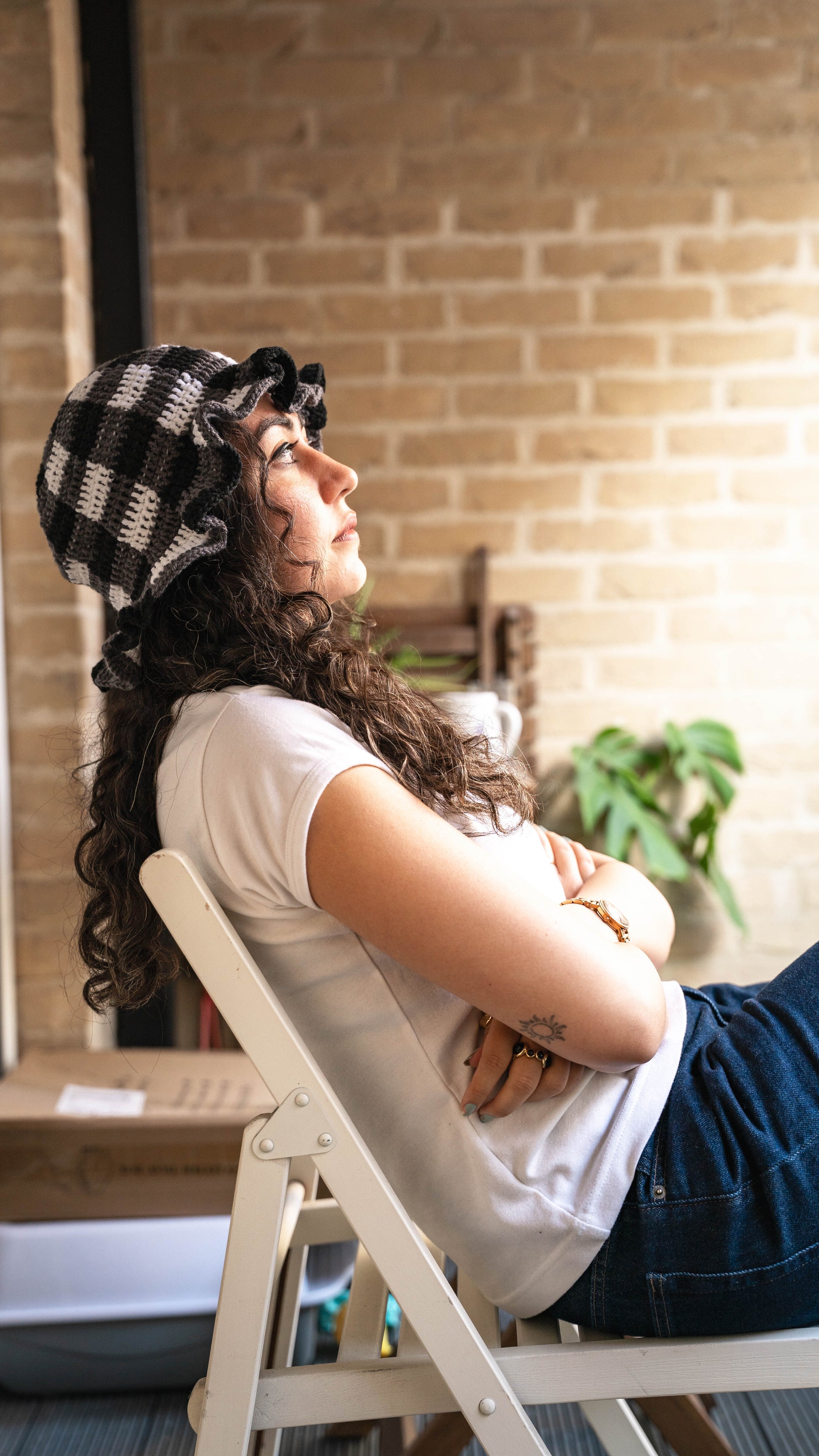Model wearing monochrome crochet bucket hat, side view