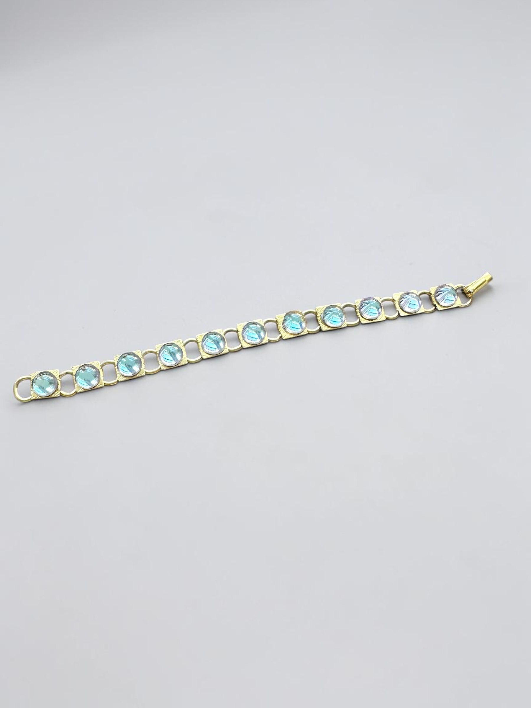 Vintage aqua glass cabochon gold tone link bracelet, laid flat