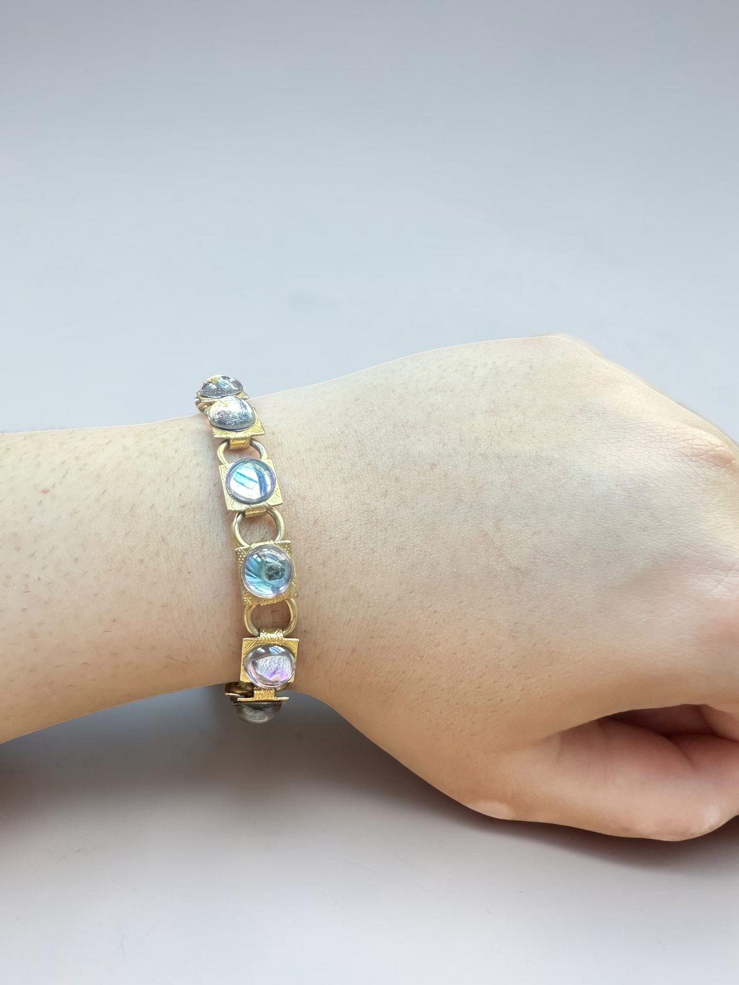 Vintage aqua glass cabochon gold tone link bracelet worn on wrist