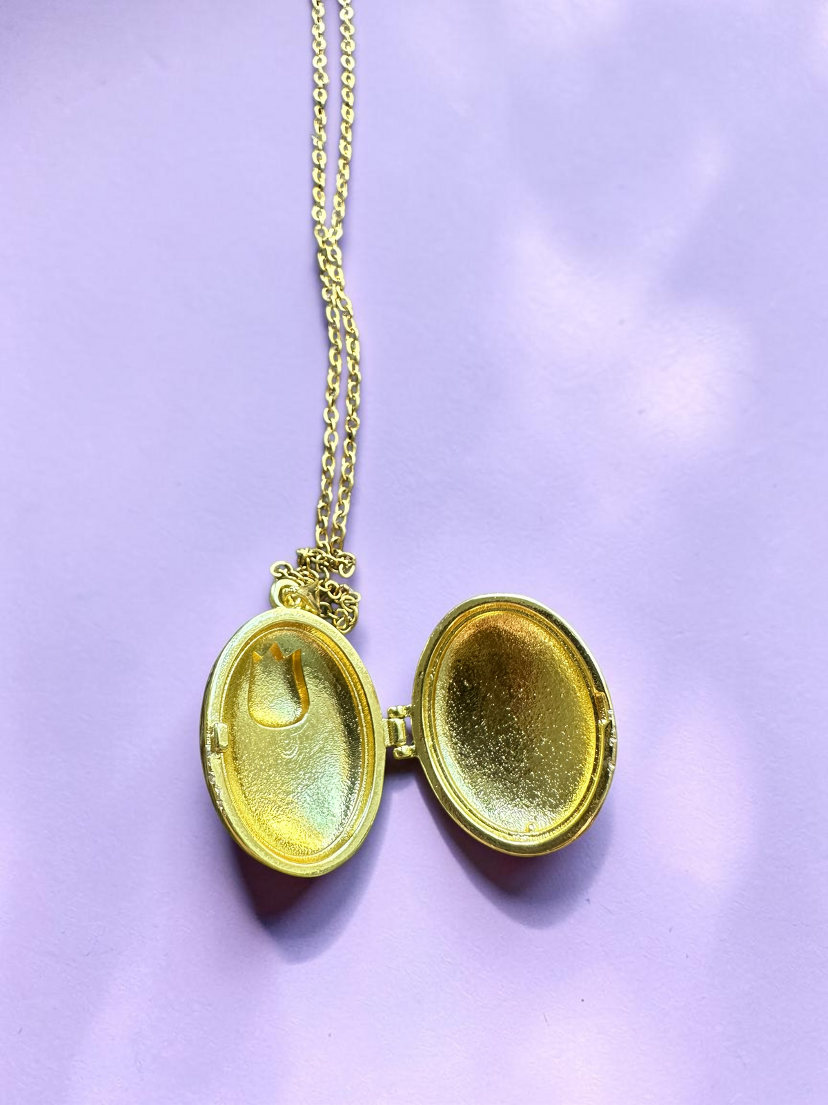 Enamel tulip locket necklace open, showing gold tone interior compartments