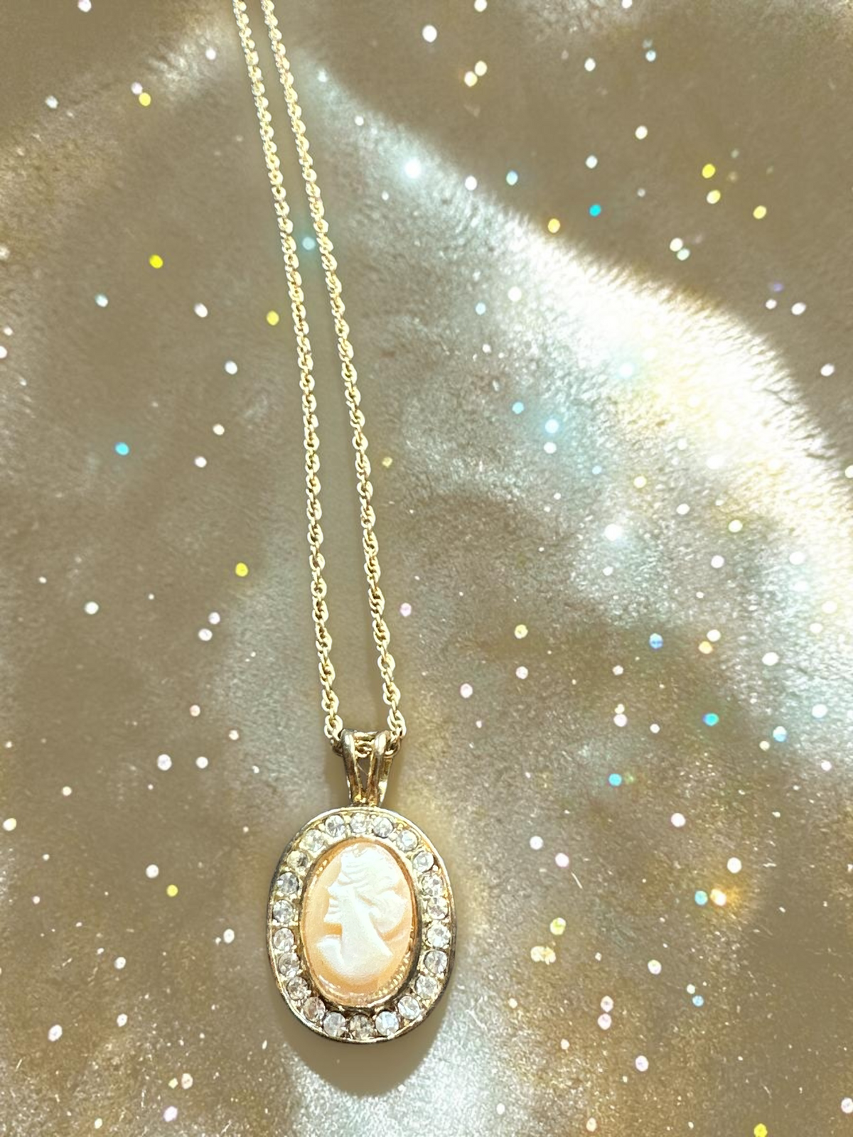 Vintage real cameo crystal halo gold tone necklace, full length on glitter background