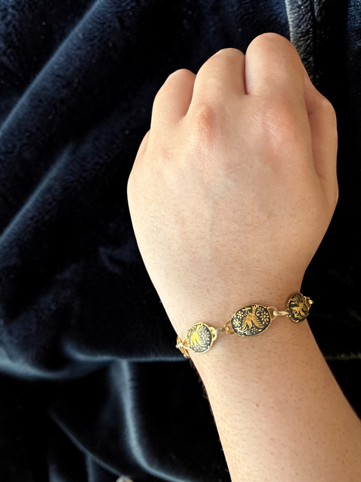 Vintage Toledo damascene gold and black enamel disc link bracelet worn on wrist