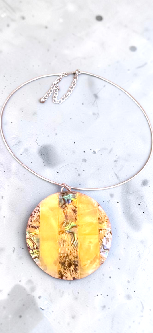 Yellow abalone shell disc choker necklace, full view on marble
