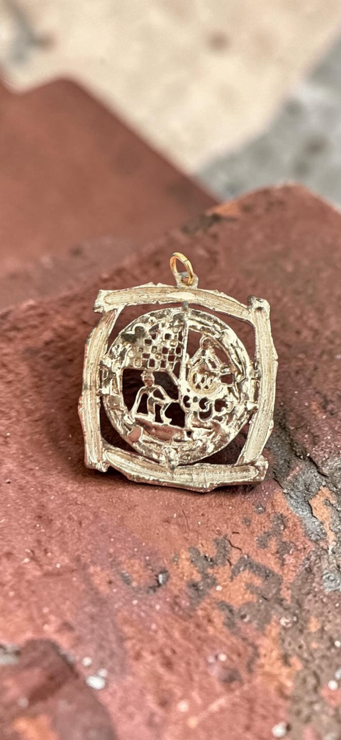 Vintage Chinese scene silver tone bamboo frame pendant, side view on stone