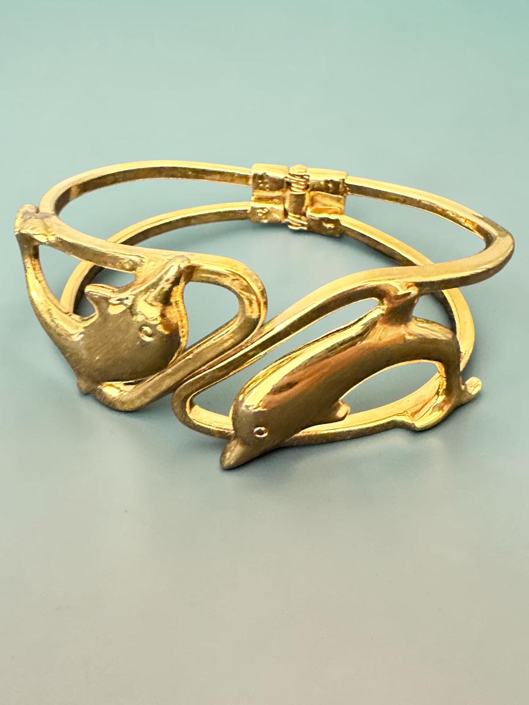 Gold tone dolphin cuff bracelet side view