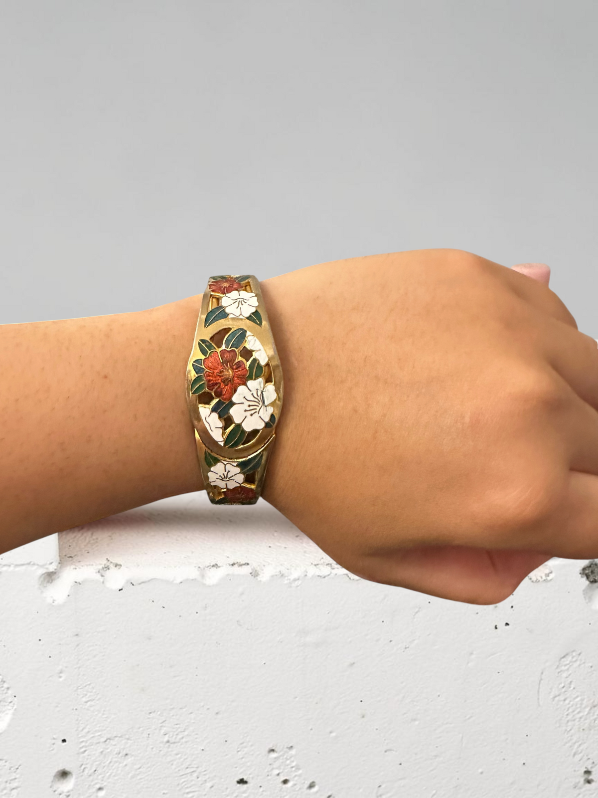 Cloisonné floral bangle worn on wrist