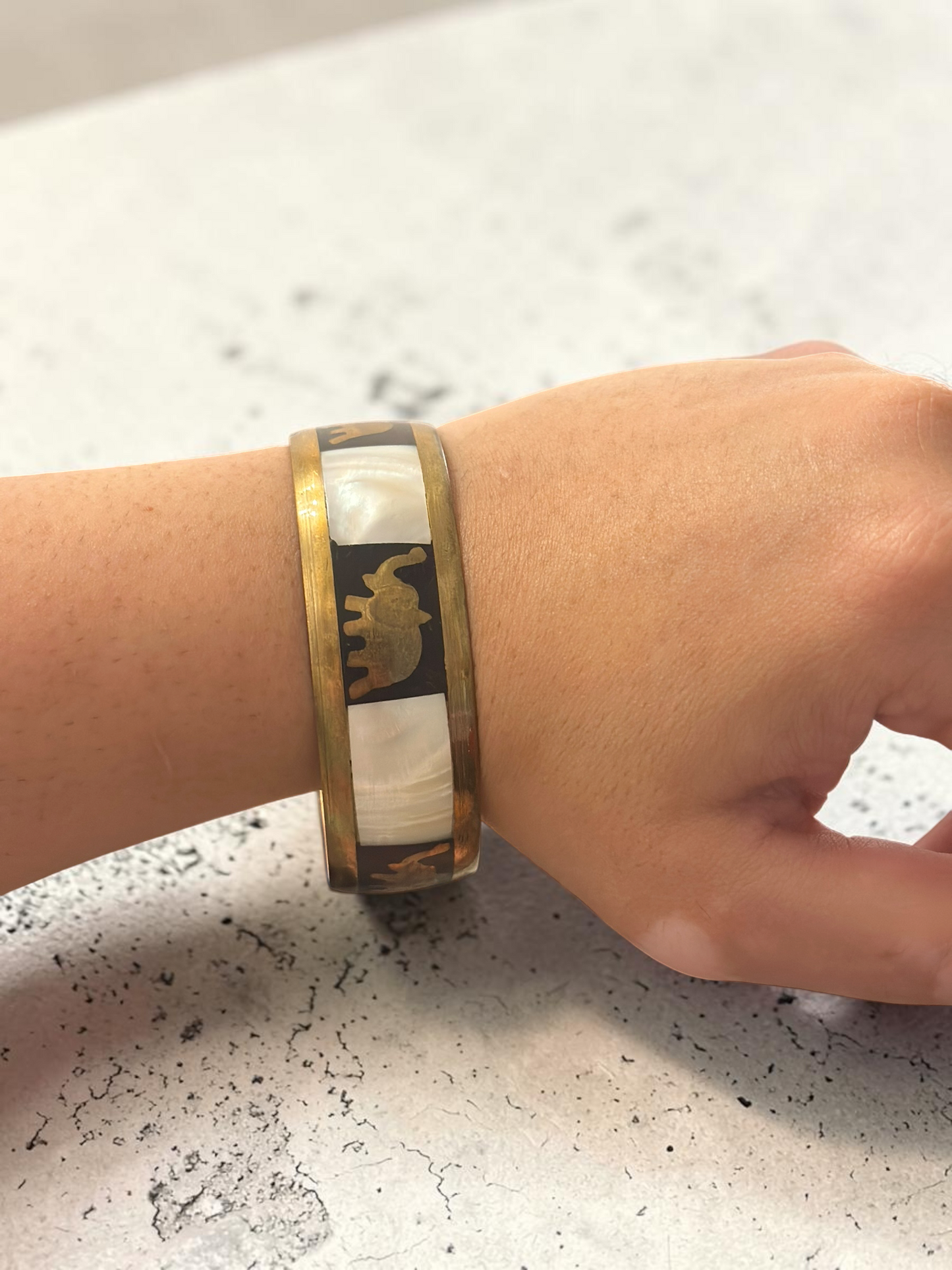 Camel mother of pearl bangle worn on wrist