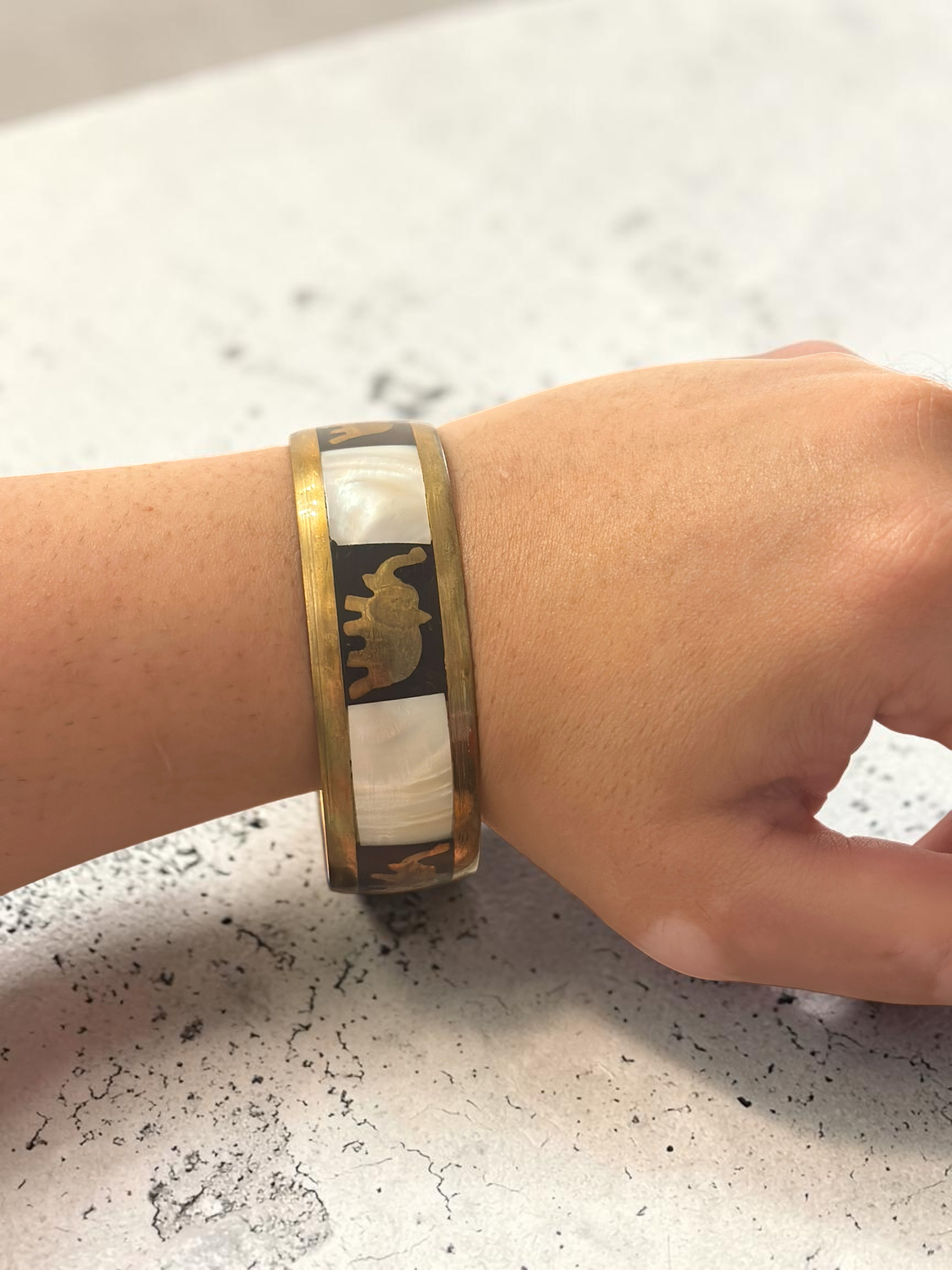 Camel mother of pearl bangle worn on wrist
