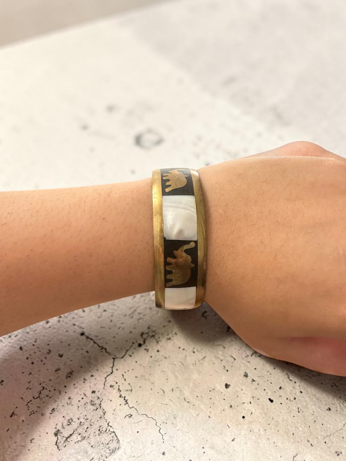Camel mother of pearl bangle side view on wrist